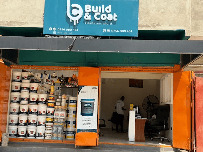 Build and Coat storefront in Ghana with teal signage and stocked paint shelves